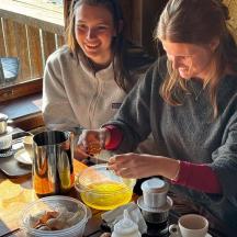 two women sitting at a table eating food