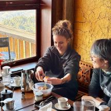 two women sitting at a table in a restaurant