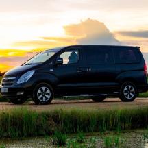 a black van parked on the side of a field