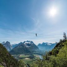 a person on a zip line in the mountains