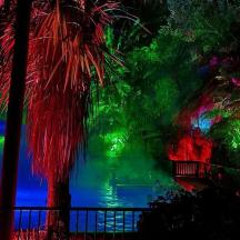 a room with a green and colorful waterfall
