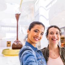 two young women standing in a museum with smiles