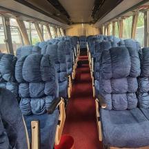 an empty train car with blue seats on it