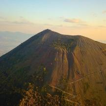 an aerial view of a mountain with trees on it