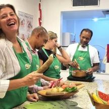 a group of people in a kitchen preparing food