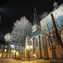 a large building with a church at night