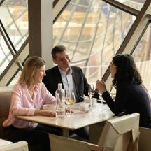 a group of people sitting at a table in a restaurant