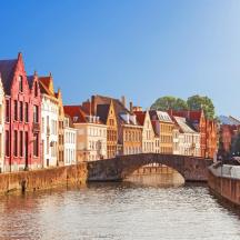 a bridge over a river in a city with buildings