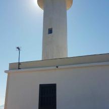 a lighthouse sitting on top of a white building