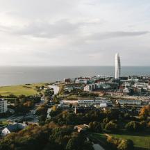 an aerial view of a city with a tall tower