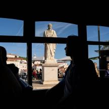 a group of people sitting in front of a statue