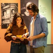 a man and a woman looking at a piece of paper