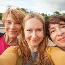a group of three women posing for a picture