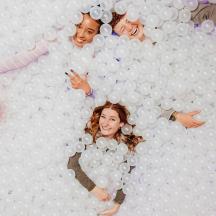 a group of people in a wall of balls