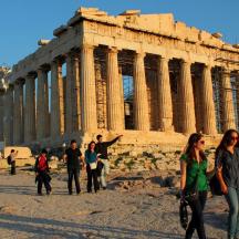 a group of people walking in front of a building