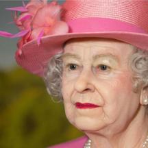 an older woman wearing a pink hat with flowers on it