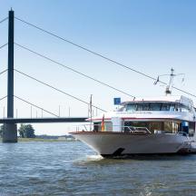 a boat in the water next to a bridge