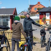 a group of people standing with their bikes