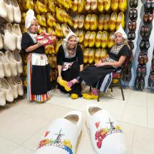 a group of three women sitting in a store with shoes
