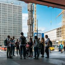 a group of people standing on a city street