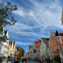 a city street with buildings and a blue sky