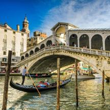 a gondola in a canal in front of a bridge