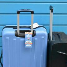 two pieces of luggage sitting next to a blue wall