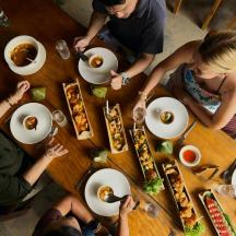 a group of people sitting around a table eating food