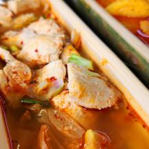 a couple of containers of food with chicken in it