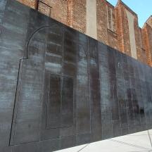 a large metal wall on the side of a building