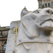 a statue of a lion in front of a building
