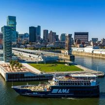 a large boat in the water near a city