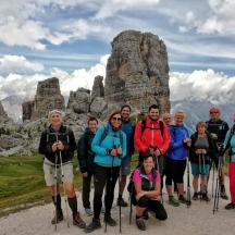 a group of people standing in front of a rock formation