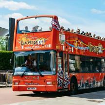a red double decker bus full of people
