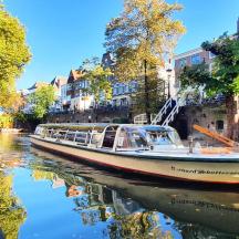 a boat is docked on a canal in a city