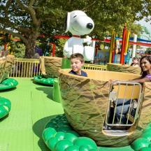 a group of children riding on a ride at an amusement park