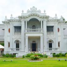 a large white building with statues in front of it