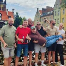 a group of people posing for a picture in a city