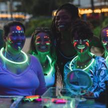 a group of women with painted faces and lights