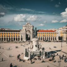 a large plaza with a fountain in front of a building