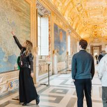 people looking at a map in the vatican museums