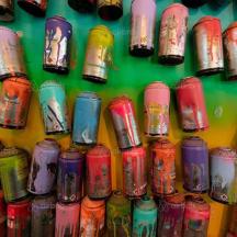 a bunch of different colored vases on a wall