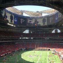 a large arena with a soccer game in it