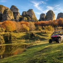 a atv driving on a trail near a rock formation