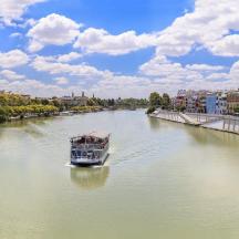 a boat traveling down a river in a city