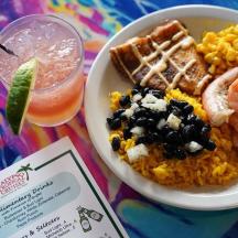a plate of food with shrimp and rice and a drink