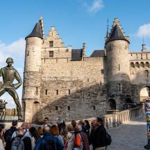 a group of people standing in front of a castle