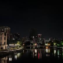 a city skyline at night with a river and buildings