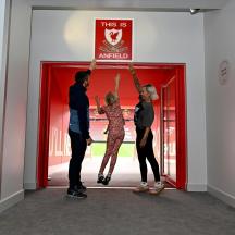 a group of people standing in front of a red door