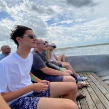 a group of people sitting on a boat
